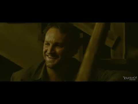 Trailer still: a shotgun on a porch rail as dawn burns through the trees