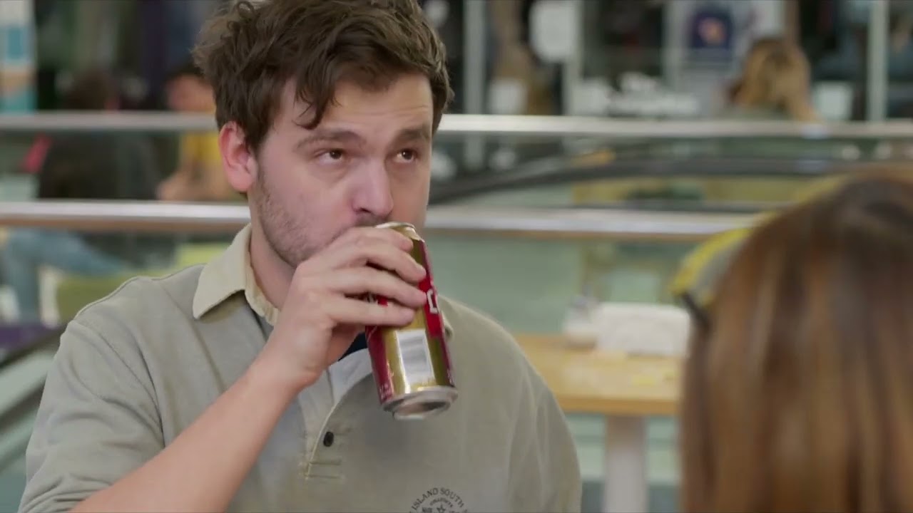 A man is going to eat spaguetti from a tupperware