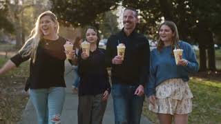 Zaxby's Man on a bench drinking a milkshake