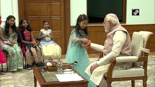 Delhi: Daughters of PMO staff tie rakhi to PM Narendra Modi