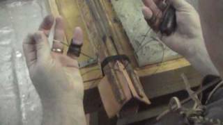 Hand stitching a piece of leather