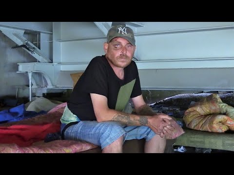 He sleeps under a bridge in the city center