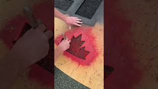 painting the CFL logo on the turf at TD Place