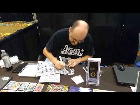 David Johnson from Solar Verse Entertainment Signing a Comic at Tremendicon 2022.