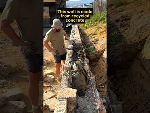 Stonemason places the final stones in a wall #mason #stonemason #retainingwalls