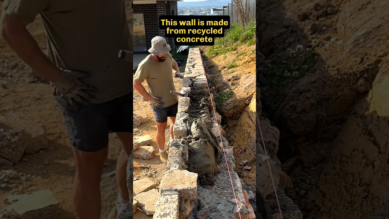 Stonemason places the final stones in a wall #mason #stonemason #retainingwalls