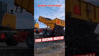 Download lagu Trucks unload basecose stones to cover damaged roads mp3