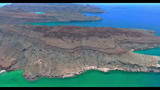 Slow Ascending Aerial View of Plateau Island near Vast Blue Seascape
