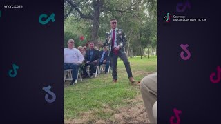 Flower man showers wedding guests with petals and laughs