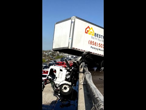 Truck dangles off California freeway after crash