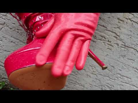 Mr. #Highheels  gets ready in the rain with high #boots an long gloves.