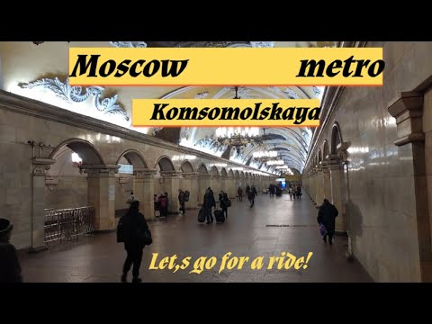 Komsomolskaya metro station, Moscow - interior view, passengers, arrival and departure of the train