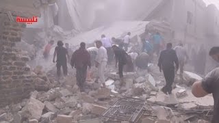 Residents search for bodies after an airstrike hits northern Homs in Syria