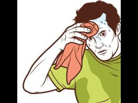 трейдер вытирает пот со лба, глядя на график