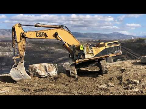 Caterpillar 375 Excavator Fighting With Huge Stones