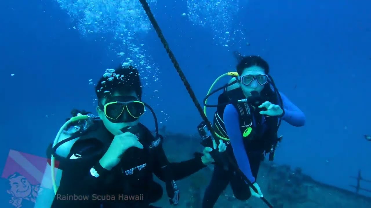 Divers preparing to jump into the ocean for the Sea Tiger wreck dive at 00:19