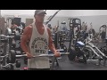 66-year-old senior doing standing bicep curls ez curl bar, proper form