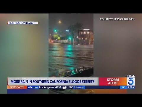 Heavy rain floods roads in Huntington Beach