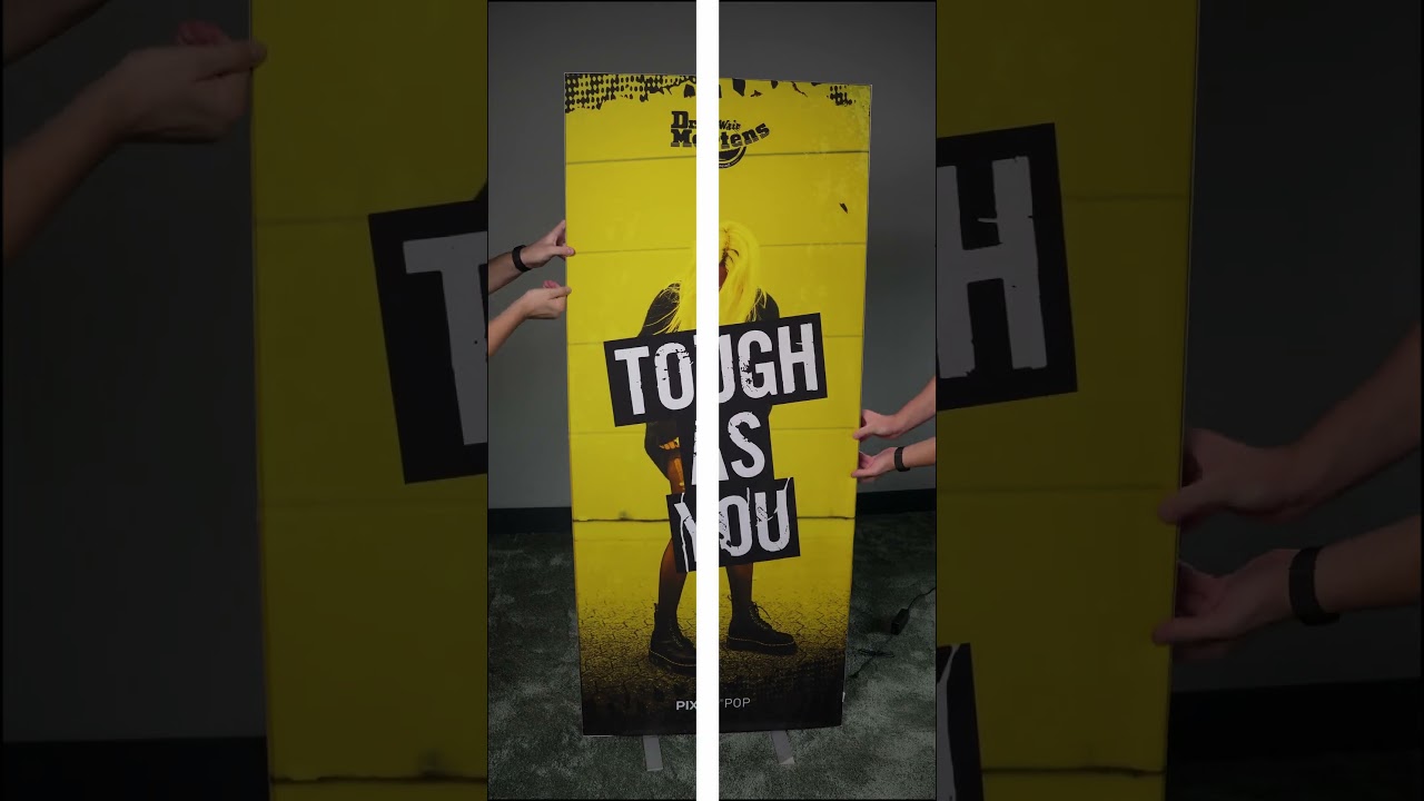 A fabric print being inserted into a PIXLIP lightbox