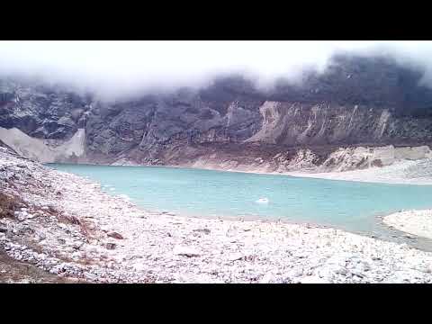 Low clouds and glacier lake Birendra's beach under Manaslu, near Samagaon village