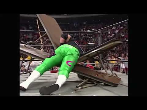 Hak knocks Hugh Morris off ladder through table