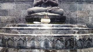Black Sandstone Buddha Statue in Miniature Building of borobudur at Monastery Bali