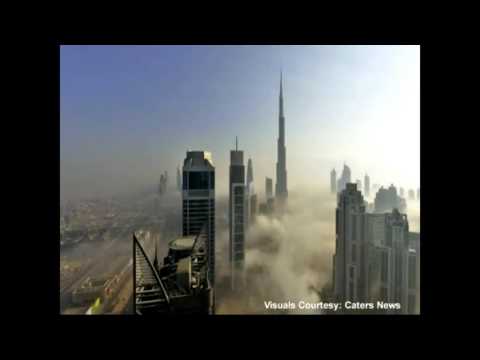 Shrouded in fog, Dubai’s skyline of skyscrapers look like islands poking from a sea of mist