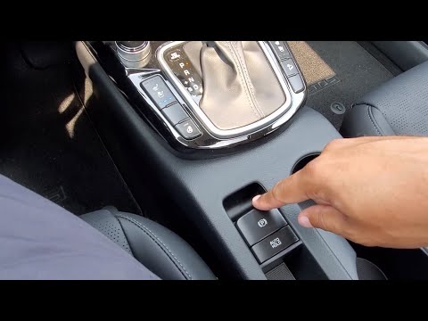 Part of a video titled 2022 Kia Seltos - How To Use Your Electronic Parking Brake w - YouTube