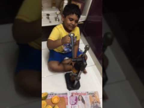 6 year old Akshaj squeezing Orange Juice