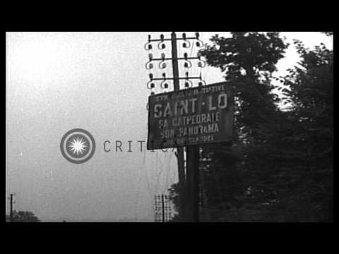 American soldiers patrol the street that leads to St. Lo, France during World War...HD Stock Footage