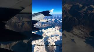 Flying above Mount Everest on a commercial airline.