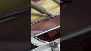 Soldering a stained glass panel.