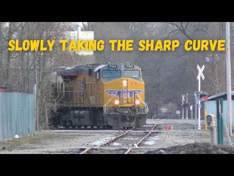 Giant grain train slow taking the sharp curve coming into town across 90 year old track