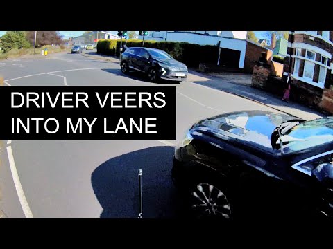 Driver performs a close-pass on a cyclist.