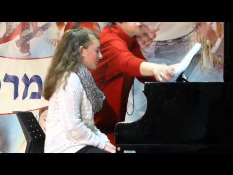 Ayelet ia playing the piano in a concert
