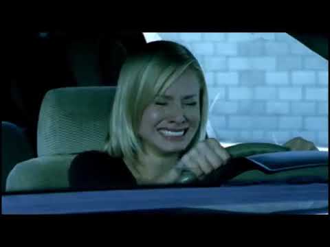 Veronica Mars Season 1 trailer frame: Veronica in noir-ish beach light with her camera