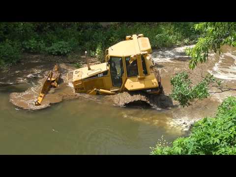 Skilled machine operator removes his CAT D6N from creek