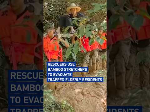 Rescuers use bamboo stretchers to evacuate trapped elderly residents
