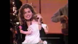 Amy Grant with her baby - tender moment on stage