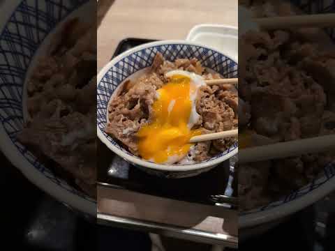 Japanese beef bowl (gyudon) with a poached egg from Yoshinoya. Fast food in Japan.