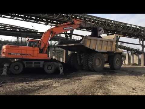 Doosan DX210W Excavator Loading Komatsu Dumper