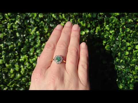 A vintage emerald and diamond cluster ring