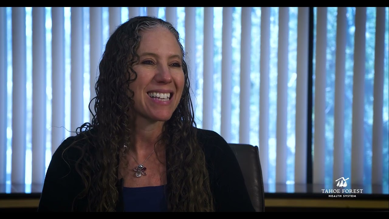Dr. Ahrin Koppel, Medical Director of Tahoe Forest Cancer Center, sitting in front of a window