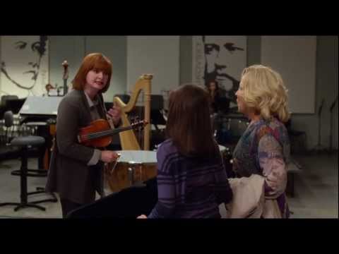 Behind-the-scenes vibe implied by the trailer: suburban kitchens, school corridors, and a warmly scored family scramble