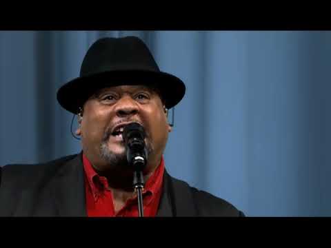 Final bows in the filmed version: amps humming, cast in line, Narrator’s guitar slung low