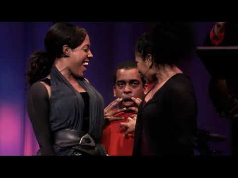 Passing Strange film trailer still: the Belasco Theatre band in silhouette as the Narrator leans into the mic