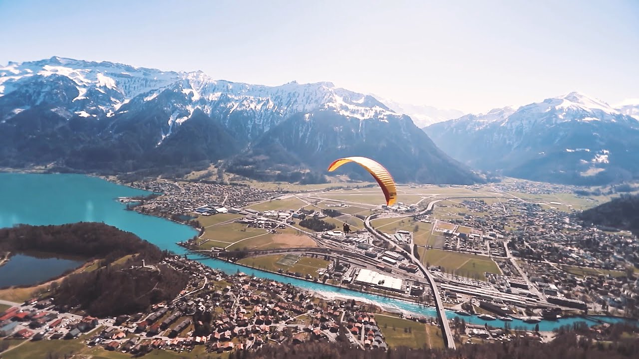Experience the thrill of paragliding over the majestic Swiss Alps.