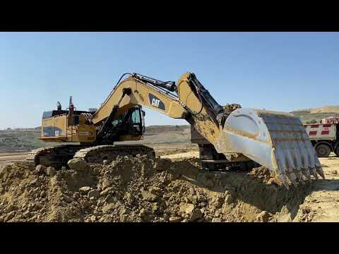 Caterpillar 374D Excavator Loading Trucks