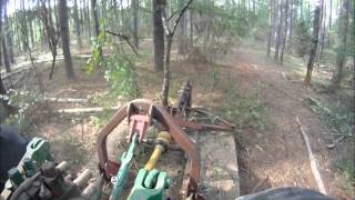 Brown Tree Cutter Clearing Between Planted Pines.wmv