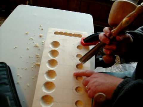 Woodcarving a Mancala game board 
